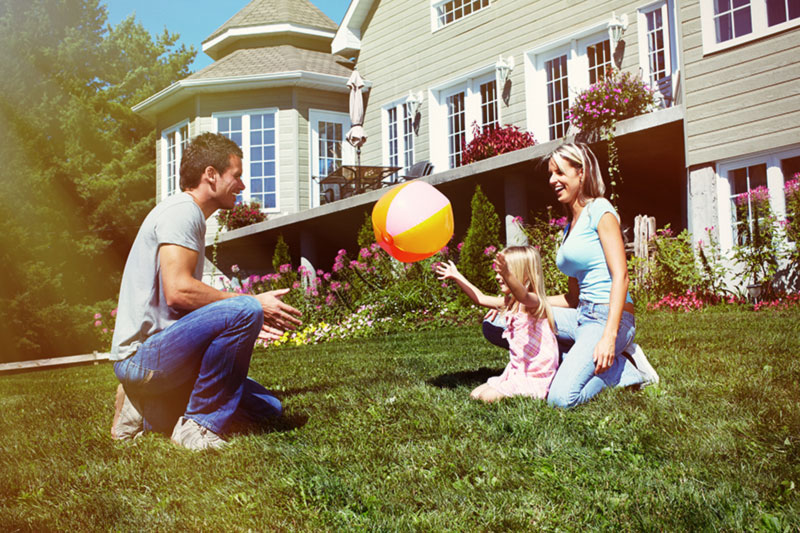 Family Together Outside New Home